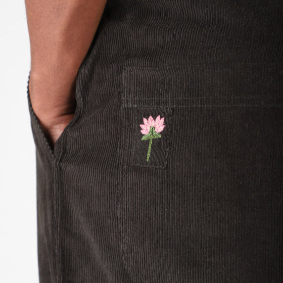 KARDO Essentials for Everyday Style and Comfort: dark corduroy garment with pink flower embroidery on pocket.