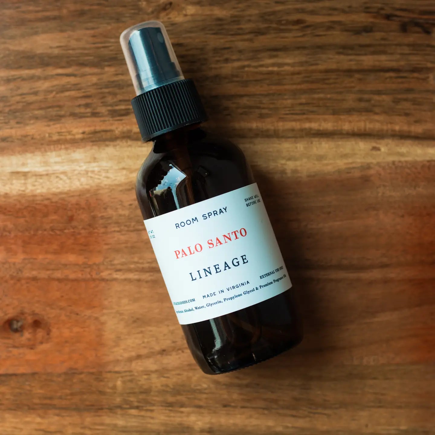 Palo Santo Lineage room spray bottle on a wooden surface, part of Lifestyle Essentials for Everyday Living.
