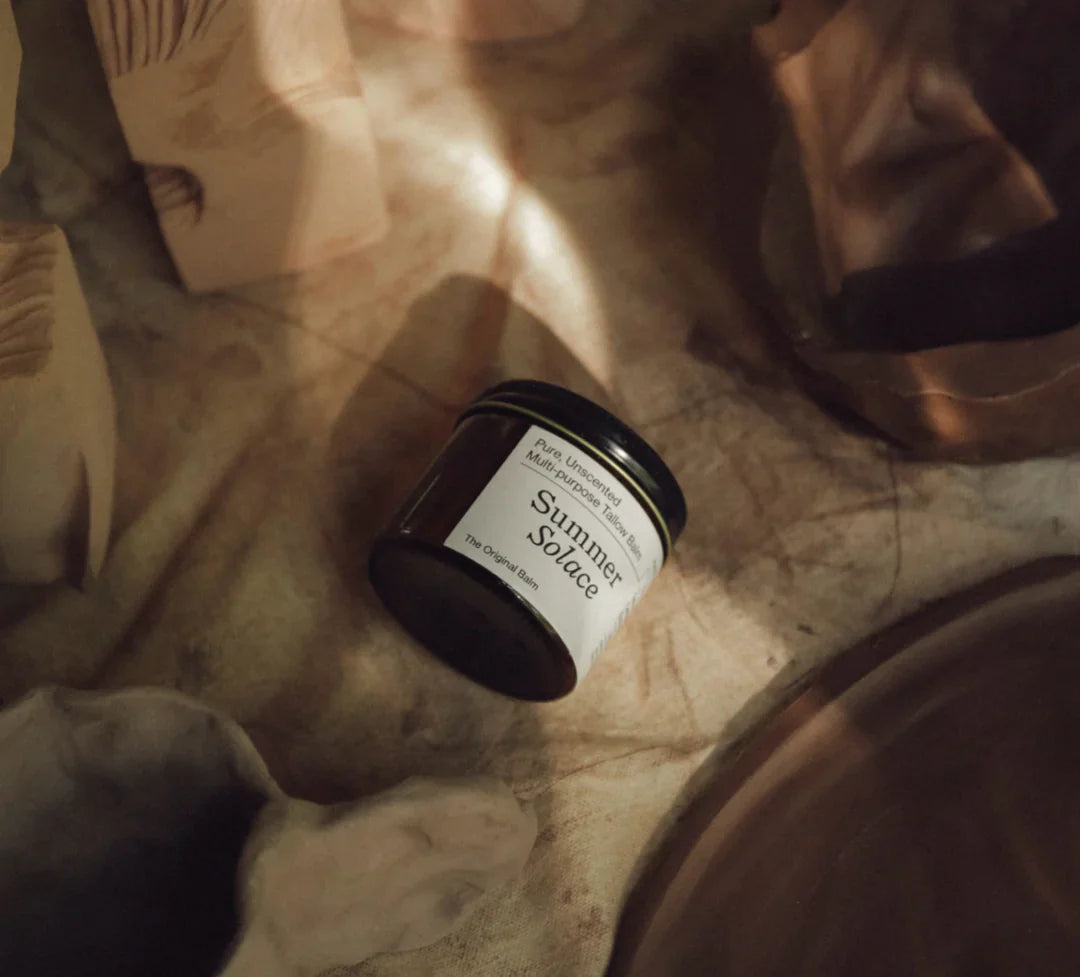 Summer Solace tallow balm jar on soft beige fabric; handmade skincare and home goods.