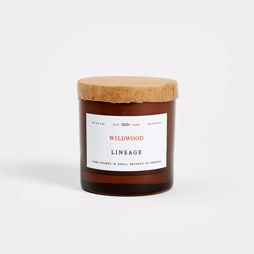 Lineage Goods Wildwood candle in amber jar with cork lid, timeless home essential.