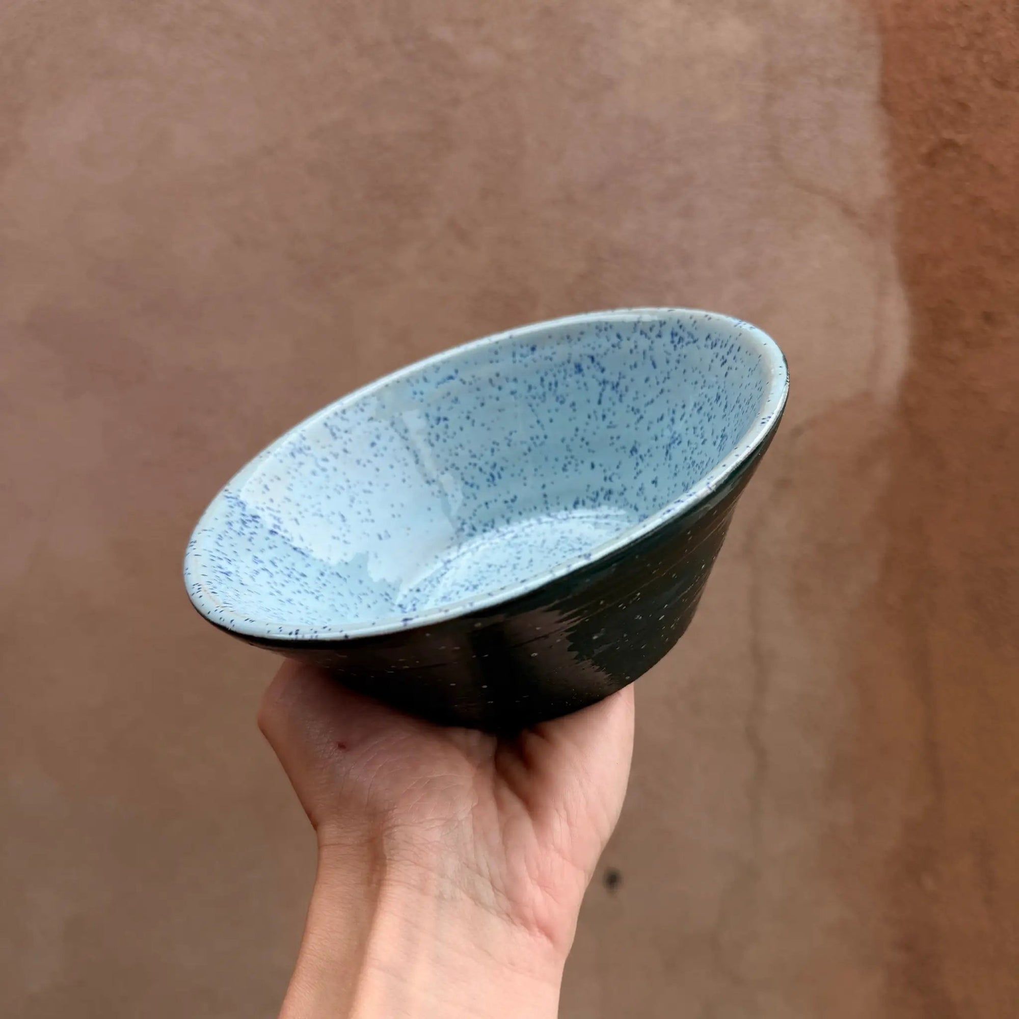 Pre-loved speckled ceramic bowl with light blue interior and green exterior, handmade and curated by Above Snakes.