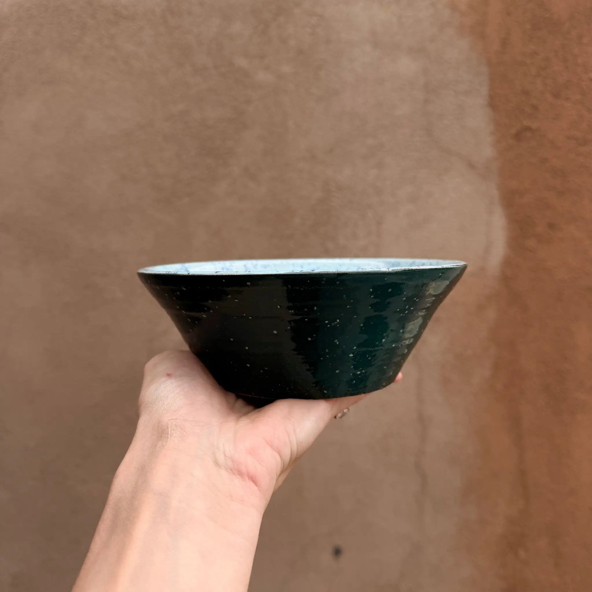 Pre-loved speckled ceramic bowl with blue interior and green exterior, handmade.