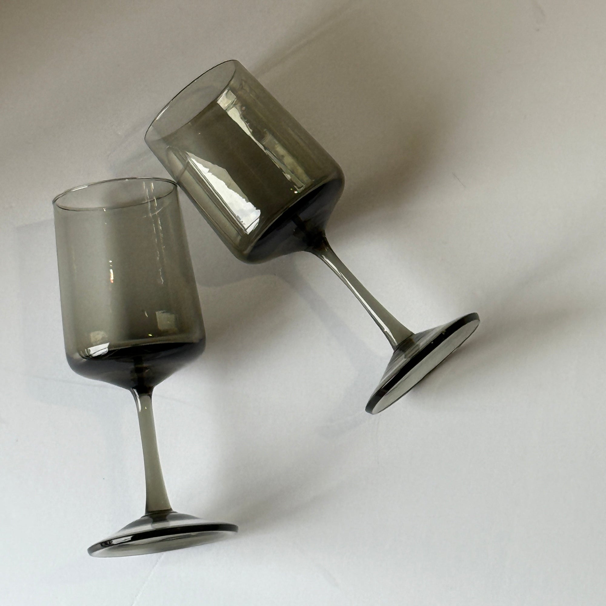 Two silver dumbbells on a white background