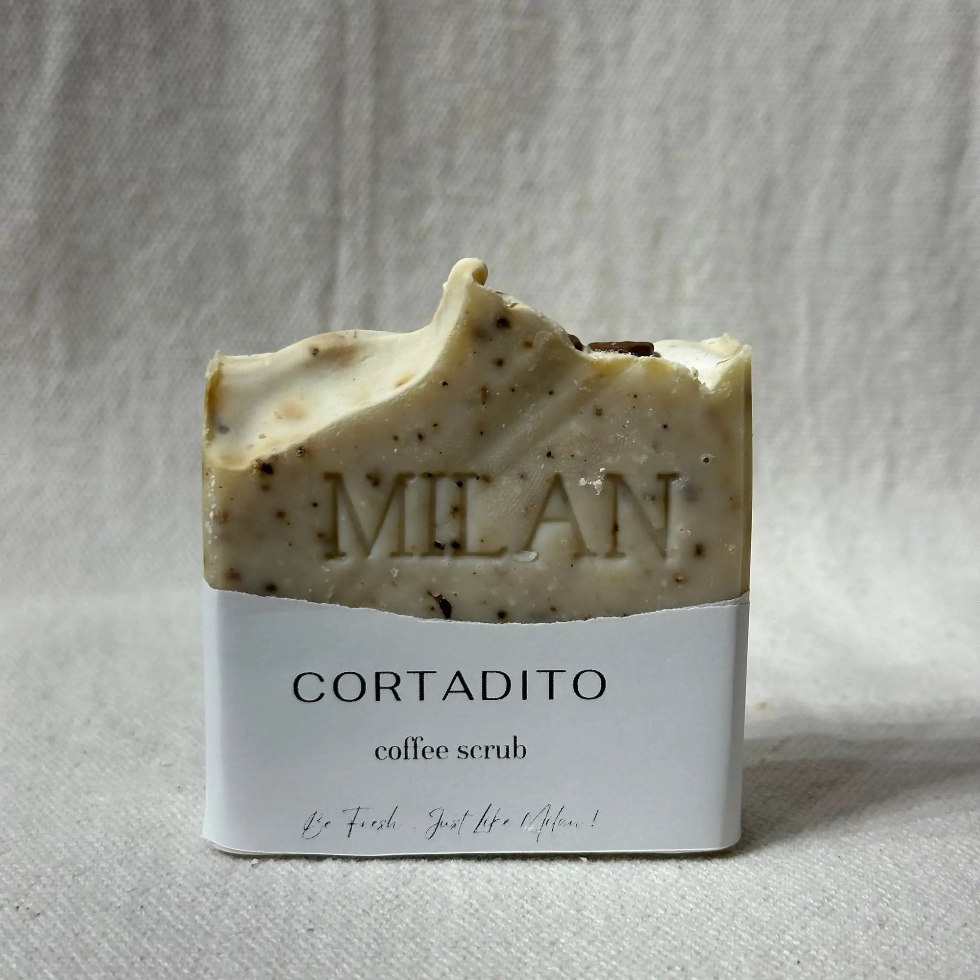 Milan Soaps Cortadito coffee scrub bar with visible coffee grounds and Cortadito label.